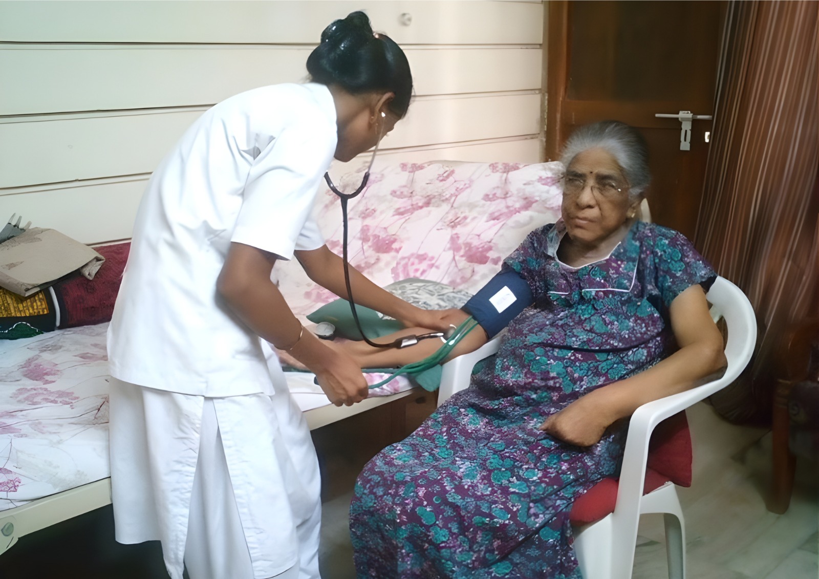 A nurse checking a patient's vitals at home.